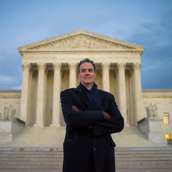 Earthjustice attorney Jim Pew stands in front of the U.S. Supreme Court on a cold winter day.