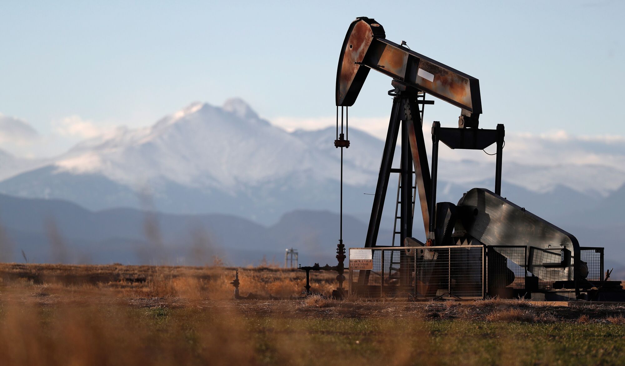 This Dec. 22, 2018, photo shows a pump jack over an oil well along Interstate 25 near Dacono, Colo.