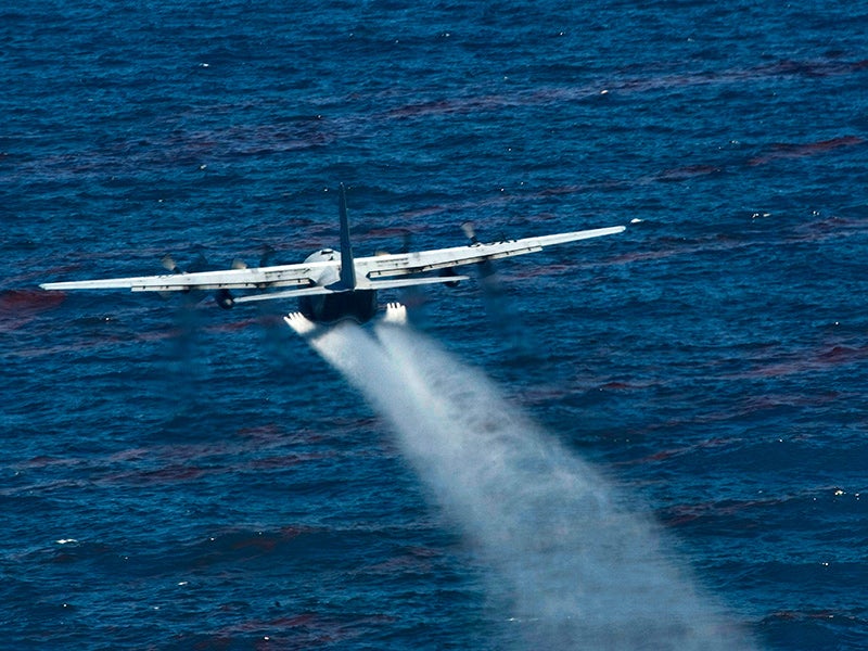 A U.S. Air Force aircraft drops an oil dispersing chemical into the Gulf of Mexico as part of the Deepwater Horizon Response effort on May 5, 2010.