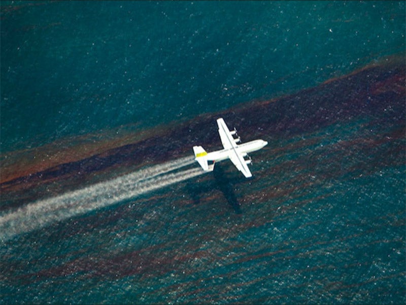 A chemical dispersing aircraft flies over the Gulf of Mexico, during the BP Deepwater Horizon oil spill.
(Photo courtesy of the Oil Spill Commission)