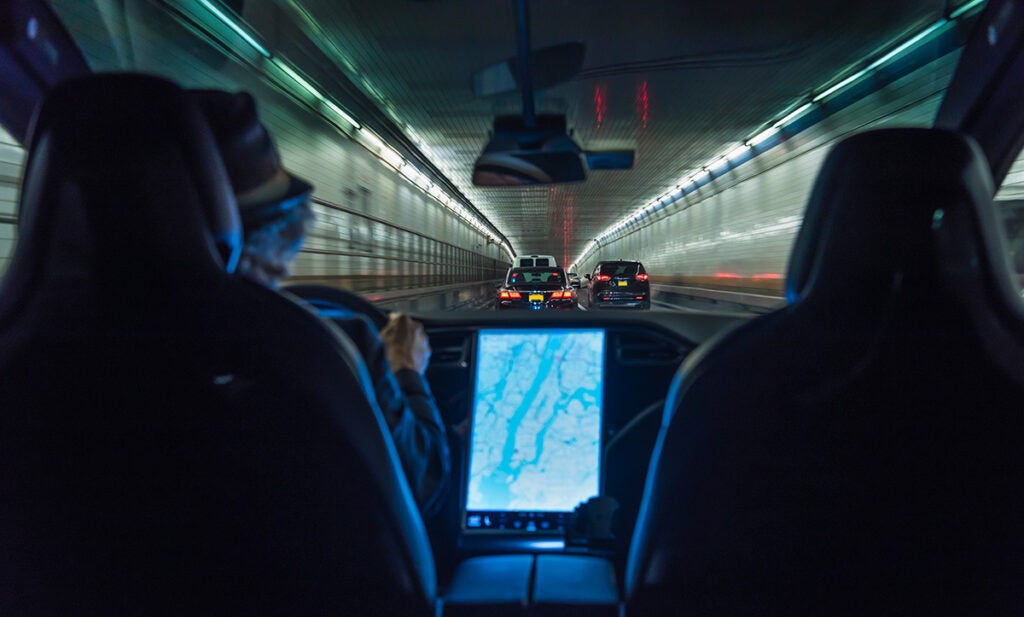 Driving an electric car in the Holland Tunnel in New York City. Because electric vehicles are more efficient in converting energy to power cars and trucks, electricity across the board is cleaner and cheaper as a fuel for vehicles, even when that electricity comes from the dirtiest grid. (Mecky / Getty Images)