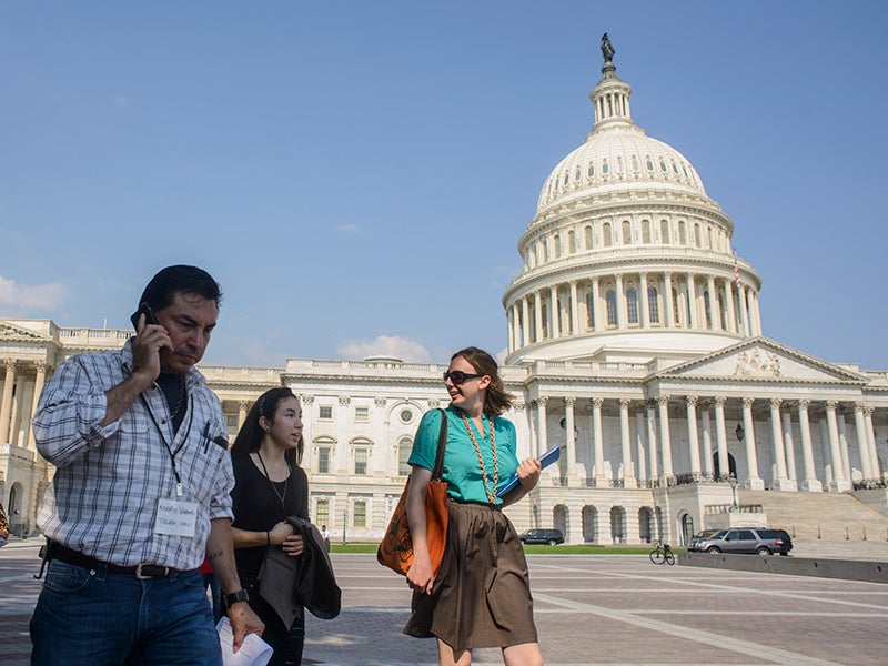 Mario Vargas, a farmworker organizer from Ohio, his daughter Myra Vargas (middle), and Alexis Guild of Farmworker Justice walk past the U.S. Capitol in July of 2013, as they head to a meeting in the Hart Senate Office Building.
(Matt Roth / Earthjustice)