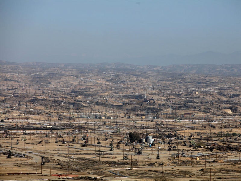 Hazy air covers an active drilling field in California.