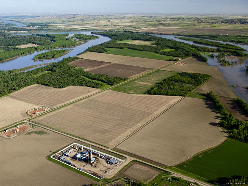 A drill rig and well pads in a floodplain, near the confluence of Missouri and Yellowstone Rivers.