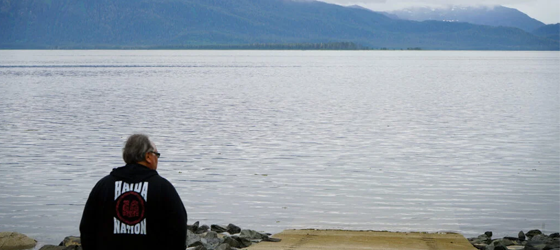 Mike Jackson, the Organized Village of Kake's Transportation Director, stands at the water’s edge on Kupreanof Island. (Rebecca Bowe / Earthjustice)