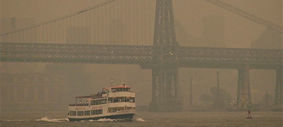 A Circle Line ferry sails past the Williamsburg Bridge as the Manhattan skyline is shrouded in smoke from Canada wildfires on June 6, 2023 in New York City. New York City is bathed in a blanket of unhealthy air as smoke from Canadian wildfires seeps across much of the eastern U.S. and Great Lakes areas. (NDZ/STAR MAX/IPx via AP)