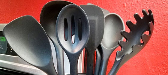 Black cooking utensils sitting on counter in a domestic kitchen. (LifestyleVisuals / Getty Images)