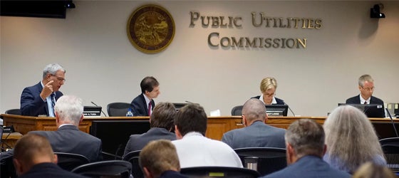 Commissioner John A. Tuma, left, speaks during a Minnesota Public Utilities Commission meeting in 2018, in St. Paul, Minn. (Richard Tsong-Taatarii / Star Tribune via AP)