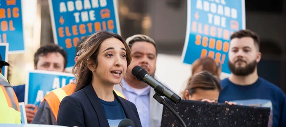 Earthjustice attorney Yasmine Agelidis speaks at a rally for electric school buses outside the Los Angeles Unified School District headquarters. The event was organized by the Los Angeles County Electric Truck and Bus Coalition. (Hannah Benet for Earthjustice)