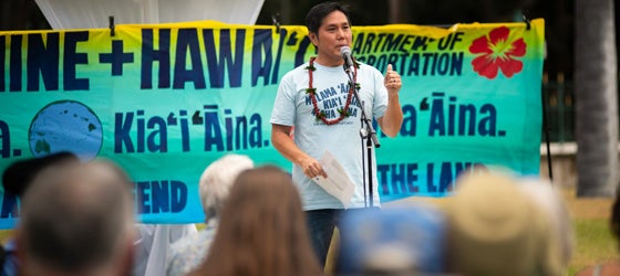 Earthjustice attorney Isaac Moriwake speaks at the Navahine + Hawai’i Department of Transportation youth climate settlement celebration at ‘Iolani Palace on June 24th, 2024. (Elyse Butler for Earthjustice)