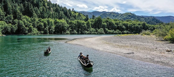 Yurok guides paddle tourists along the Klamath River in traditional canoes hand crafted from Redwood trees. (Robert Gauthier / Los Angeles Times via Getty Images)