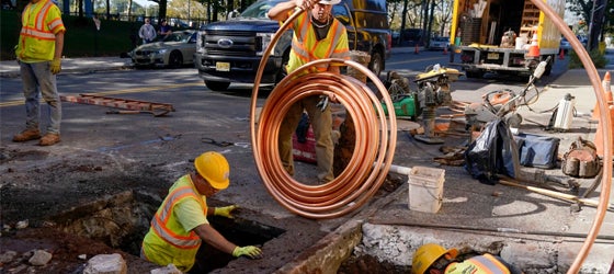 Workmen prepare to replace old water pipes with new copper pipes in Newark, New Jersey in 2021. The city replaced nearly all of its 23,000 lead service lines with new copper pipes. (Seth Wenig / AP)