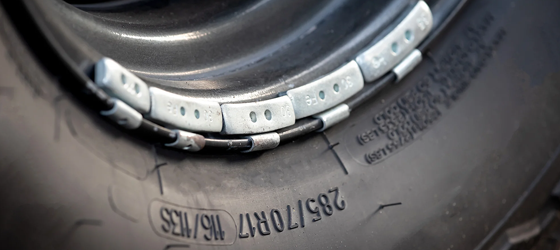 Lead weights on the rim of a car wheel, used for balance. (Ratchat / Getty Images)