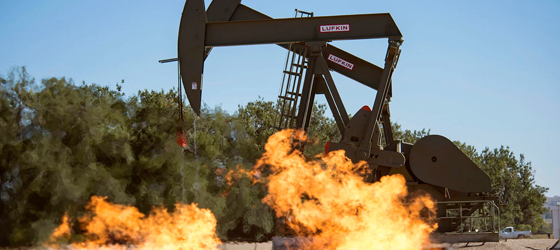 Flaring natural gas burns by jack pumps at an oil well near Buford, North Dakota in the Bakken oil fields. (William Campbell / Corbis via Getty Images)