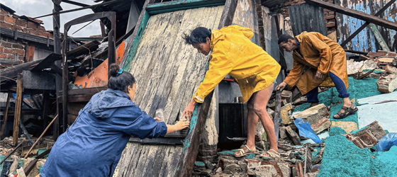 A family salvages belongings from the rubble of their home after it collapsed during Hurricane Melissa's passage through Cuba on Oct. 29, 2025. (Yamil Lage / AFP)