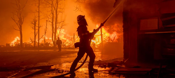 Firefighters battle the Eaton Fire in strong winds as many homes burn on January 7, 2025 in Pasadena, California. (David McNew / Getty Images)