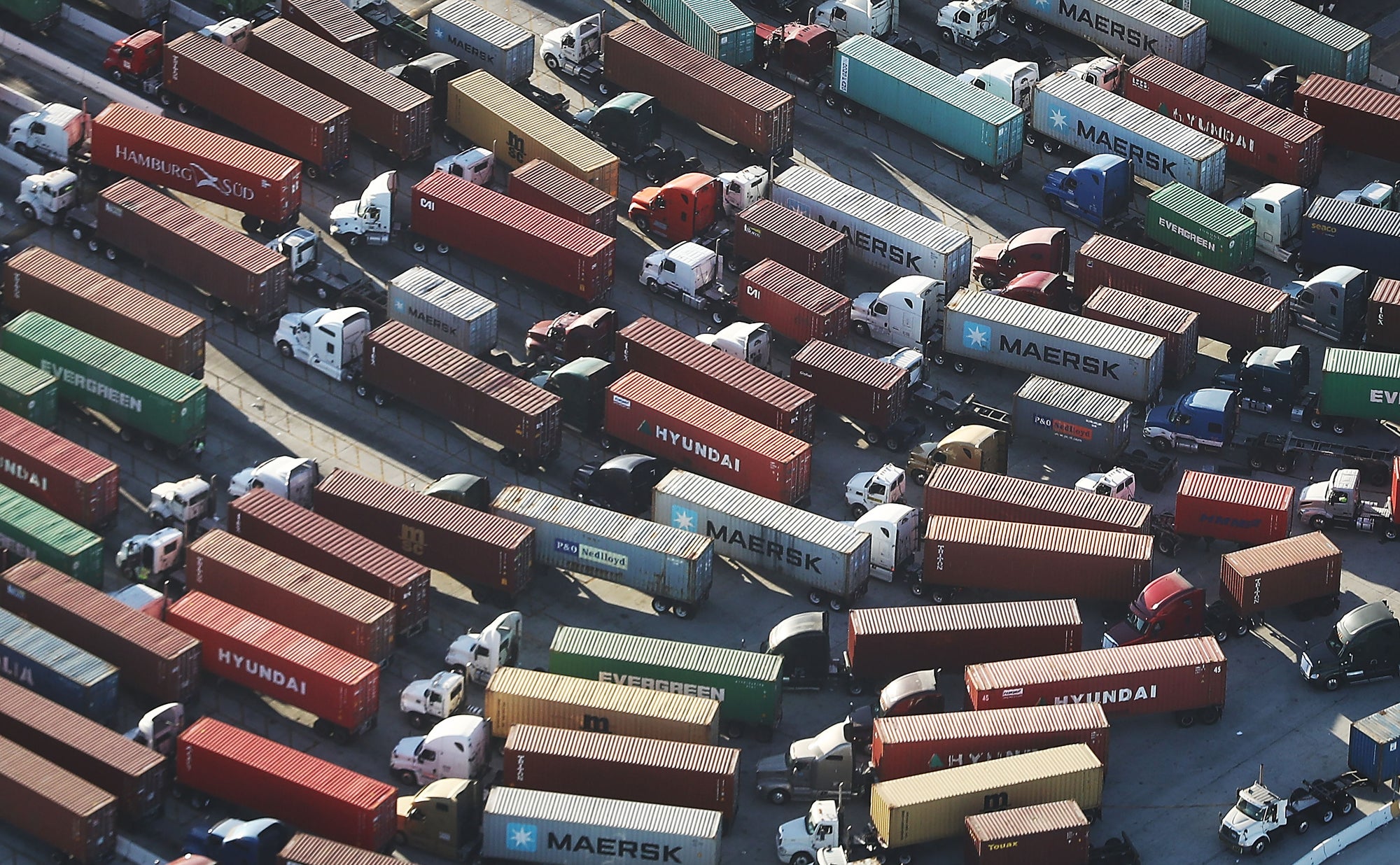 Trucks haul shipping containers at the Port of Los Angeles, the nation's busiest port. Their emissions create diesel death zones along freight lines and freeways throughout the state. Trucks produce the pollution for 40% of California’s unhealthy smog problem.