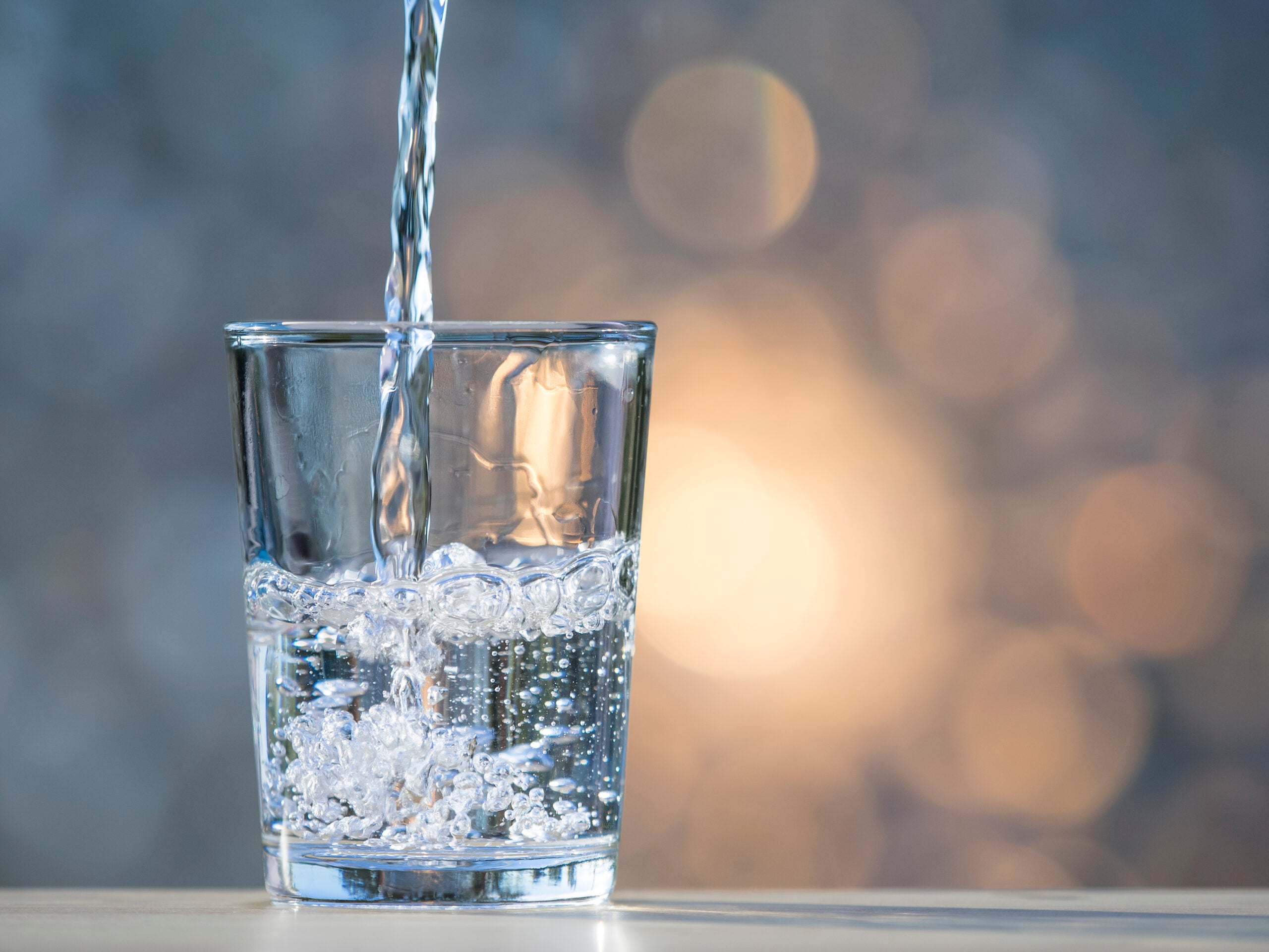 Water is poured into a drinking glass.