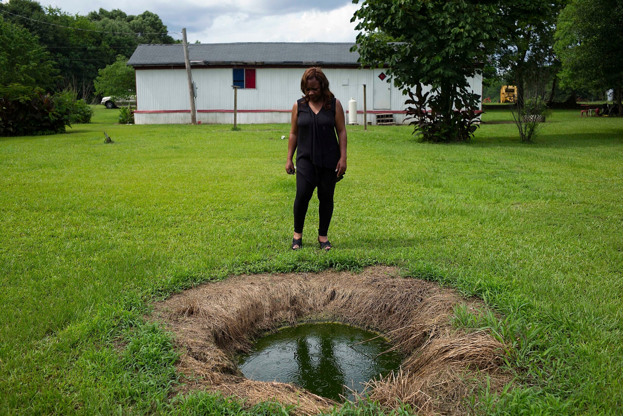 Catherine Coleman Flowers stands over a pool of raw sewage outside a home in White Hall, Alabama. For over a decade Flowers has worked as an advocate in the Black Belt, where improper sewage treatment has put the population at risk of infectious diseases.
(Bob Miller / Redux)