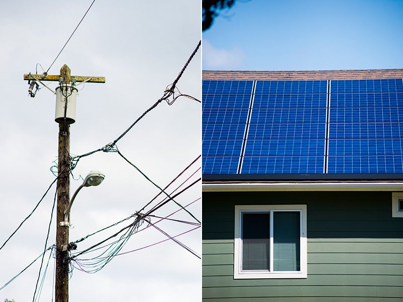 Powerlines and rooftop solar panels in Oahu, Hawaii.