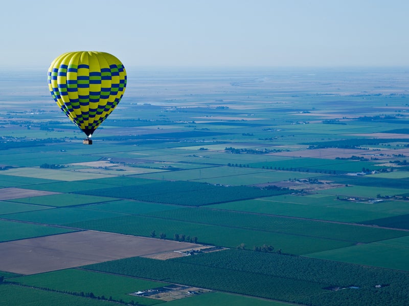 A hot air balloon floats before the smoggy backdrop of California's Central Valley outside of Sacramento.