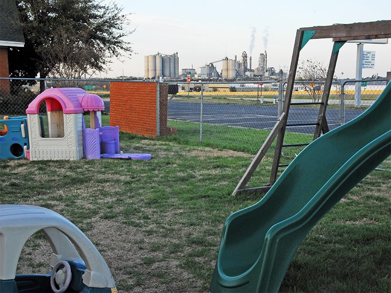 An industrial incinerator frames a church playground in Midlothian, Texas.