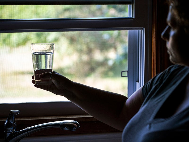 Barbara Deardorff draws water from her tap in Wheatfield, Indiana. A coal ash plant has contaminated Wheatfield's groundwater with dangerous chemicals.