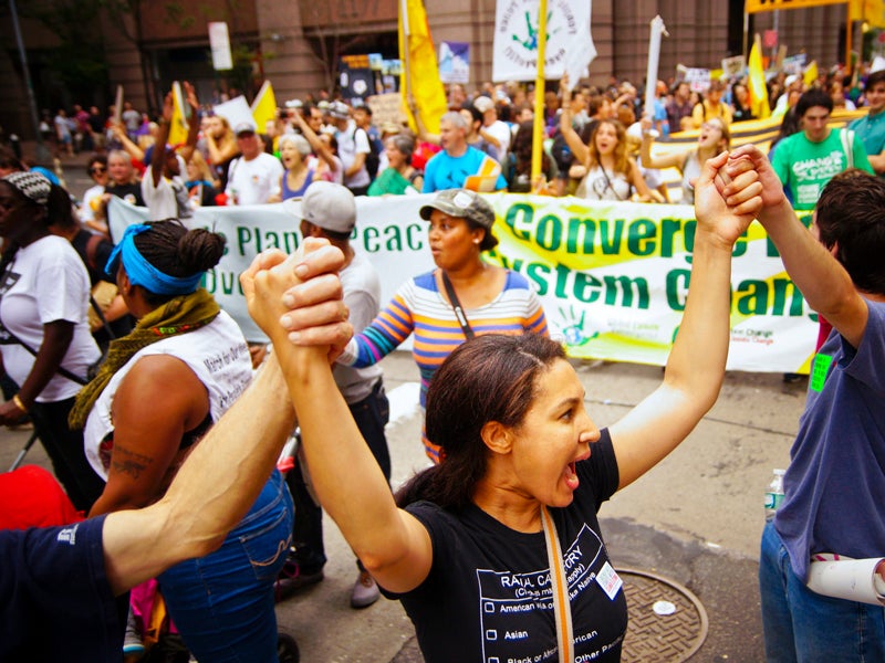 Members of Global Climate Convergence march in the 2014 Peoples Climate March. Saturday’s Peoples Climate March in Washington, D.C., will be an expression of solidarity, determination and hope for the future.
