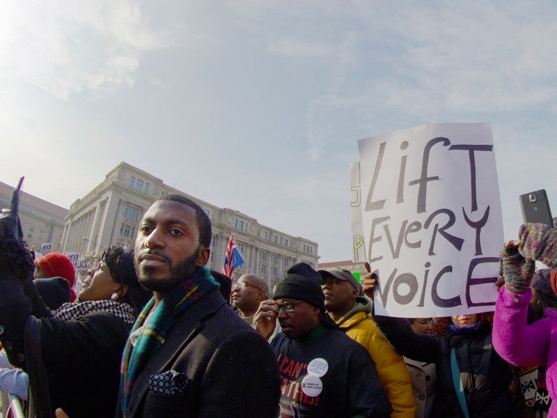 Black community members speak out against racism at the 2014 Justice for All march in Washington, D.C. From housing to education and from health care to environmental justice, Trump seeks to set our communities back.