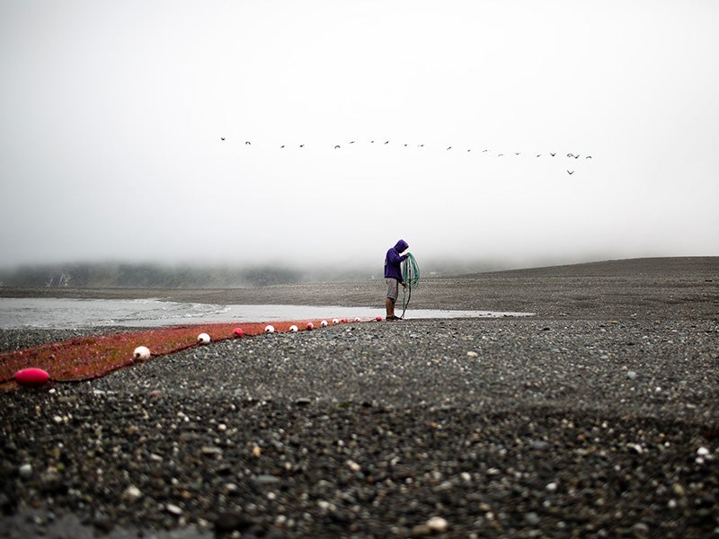 Ta-tes Boulby, a member of the Yurok Tribe, fishes at the mouth of the Klamath River in Northern California. July 7, 2018.
(Martin do Nascimento / Earthjustice)