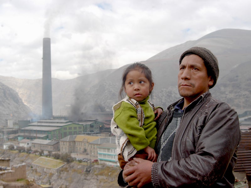 Pablo and his daughter in front of the metal smelter in La Oroya in 2008