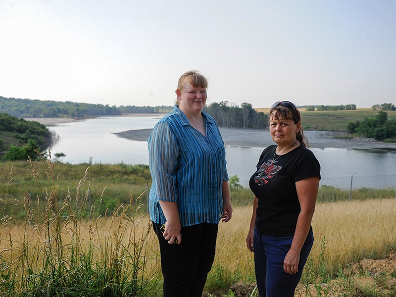 Pennsylvania residents Sabrina Mislevy and Barbara Reed stand near the Little Blue Run coal ash dump site.