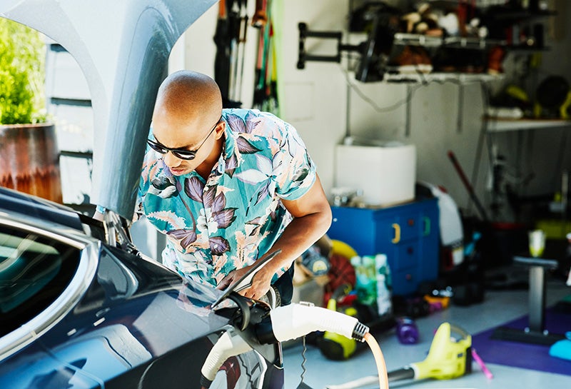 A man charges an electric car at home before a family trip in Washington state.