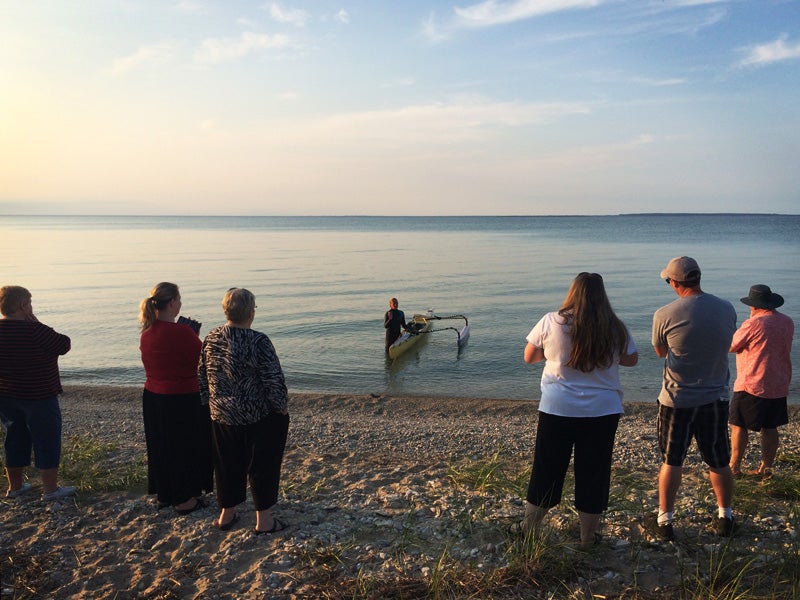 Margo Pellegrino comes ashore in Wilderness State Park in Michigan to take a day off from her journey where she is greeted by family.