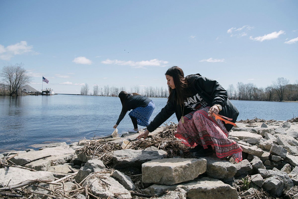 Menominee Tribal members clean up trash along the lakeshore at Shawano County Park, Wisc.