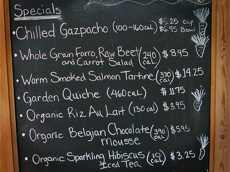 Calories are listed on a chalkboard menu at a restaurant.