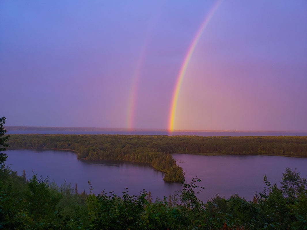 Double rainbows in the sky, from Mission Hill Overlook, overlooking Bay Mills Indian Community with Spectacle Lake and Lake Superior in the background.