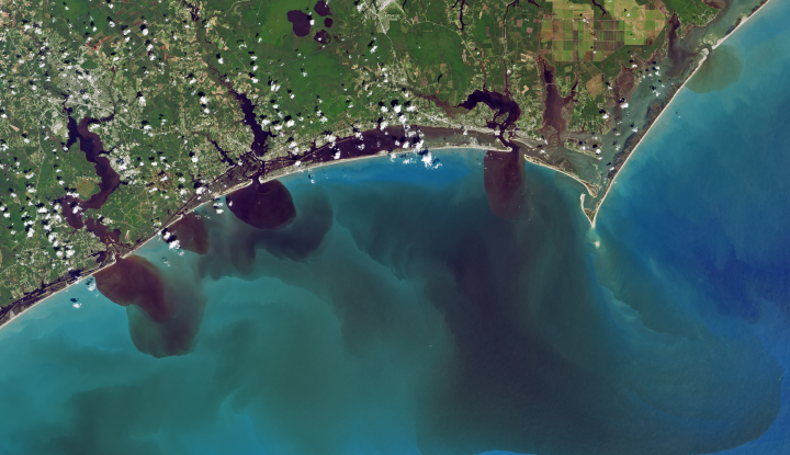 This NASA satellite image of North Carolina's coast shows water discolored by excess soils, sediments, decaying leaves, pollution and other debris after Hurricane Florence.
(Photo Courtesy of Joshua Stevens / NASA)
