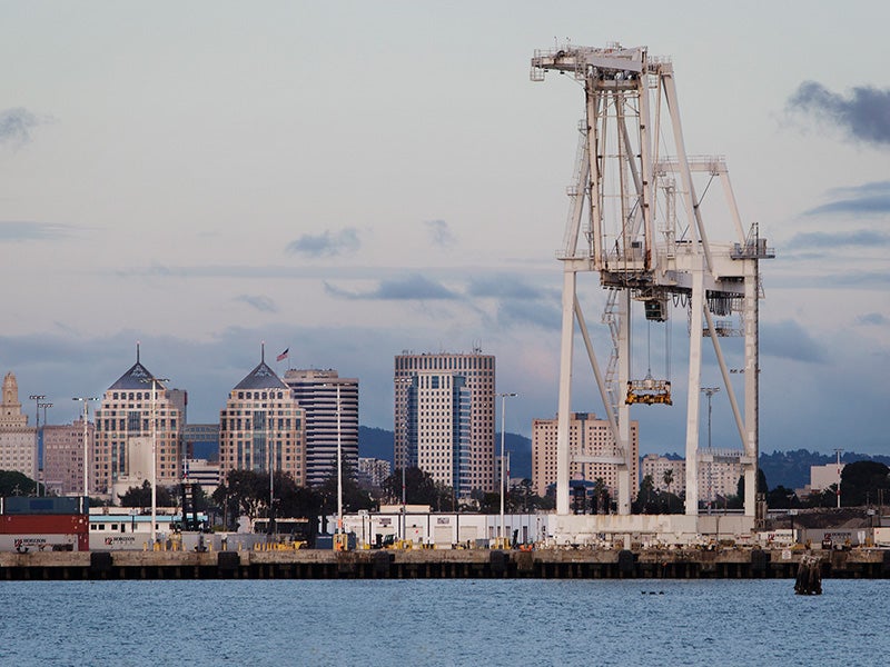 The Oakland skyline, behind the Port of Oakland. The Port is one of the largest container ship facilities on the West Coast. (Chris Jordan-Bloch / Earthjustice)