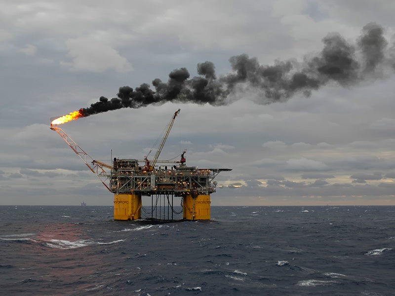 A tension-leg oil production platform burns off unrecoverable gas and leaves a plume of smoke in the Gulf of Mexico.
