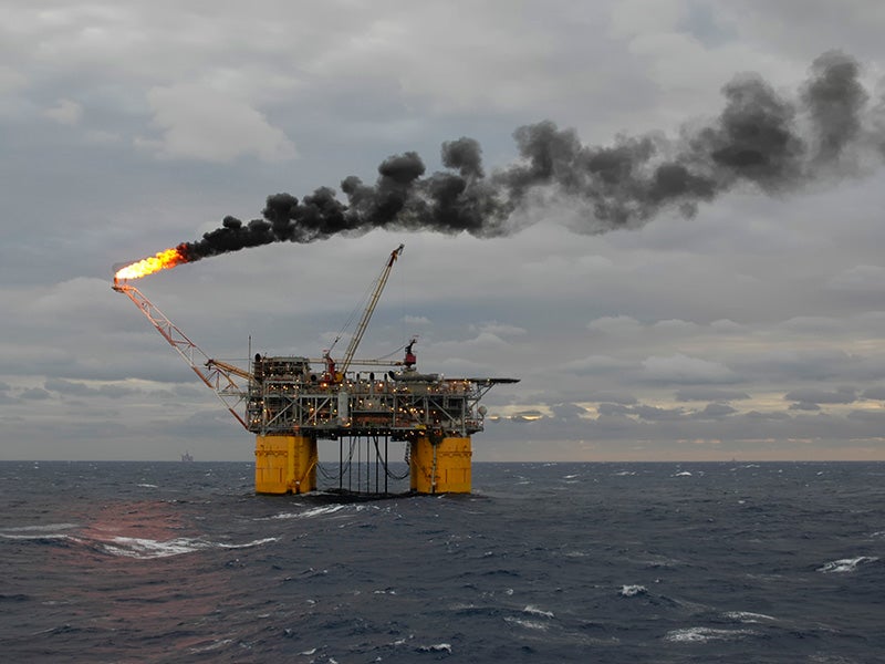 A tension-leg oil production platform burns off unrecoverable gas and leaves a plume of smoke in the Gulf of Mexico.
(Land by Sea / Getty Images)