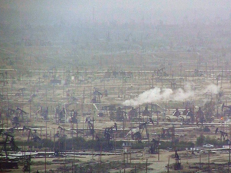 Hazy air covers an active drilling field in California.