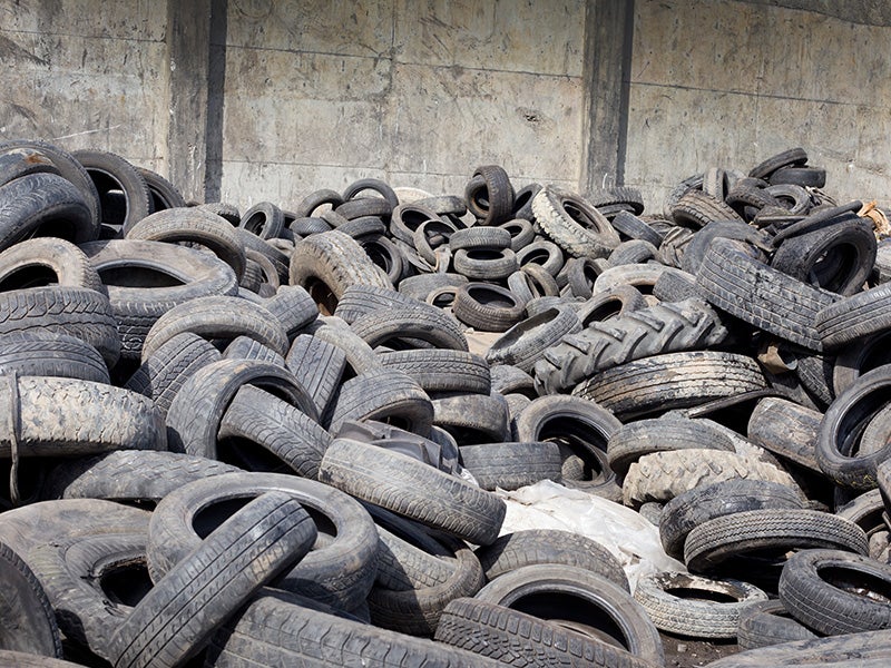 Old tires, stocked for recycling.