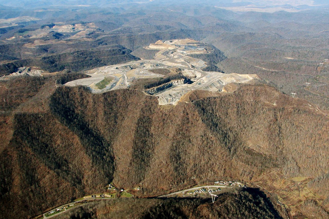 In the past few decades, an area the size of Delaware has been flattened.
Coal companies first raze an entire mountainside, ripping trees from the ground and clearing brush with huge tractors. This debris is then set ablaze as deep holes are dug for explosives.
Explosive is poured into these holes and mountaintops are literally blown apart. As much as 800 to 1,000 feet are blasted off the tops of mountains order to reach thin coal seams buried deep below.
(OVEC)