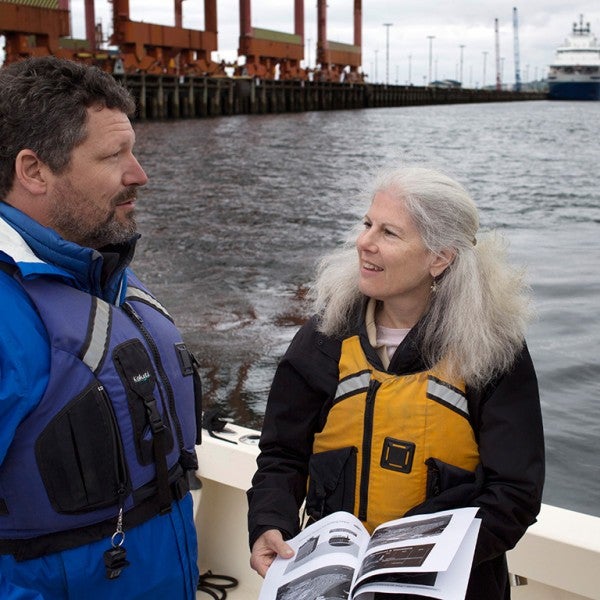 Managing Attorney Patti Goldman speaks with Earthjustice client and Puget Soundkeeper Chris Wilke at Puget Sound on April 28, 2015. The icebreaker ship Aiviq (background) is part of Shell's Arctic drilling fleet.