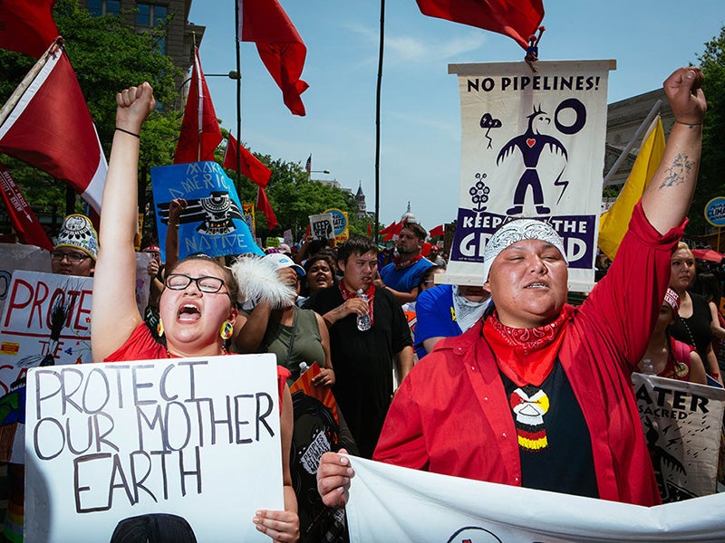 Rose Whipple, left, of St. Paul, Minnesota, who spoke of fighting for our Earth, marches next to her friend Amber Cross of Bemidji, Minnesota.