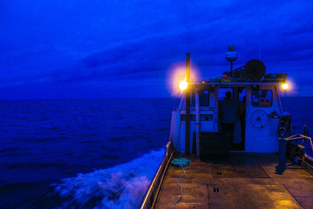 The Little Mealie, a tribal fishing tug boat going out on Lake Superior before dawn.