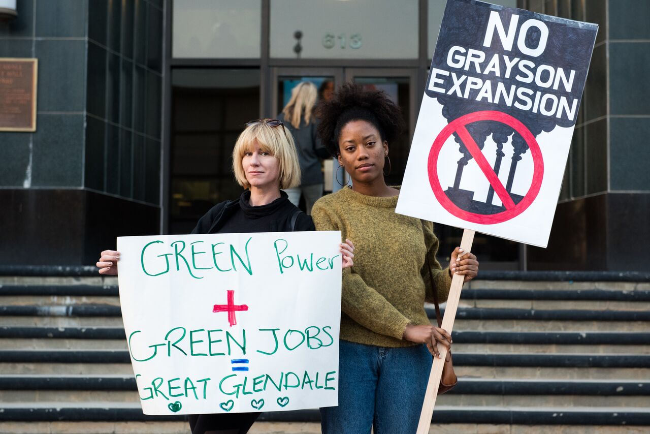 Residents protest the $500 mil proposed gas plant for their community at a rally before a city hearing.