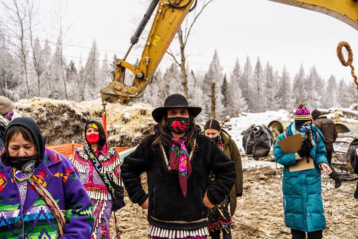Environmental activist Winona LaDuke, center, and water protectors stand in front of the construction site for the Line 3 oil pipeline near Palisade, Minn., on Jan. 9, 2021.