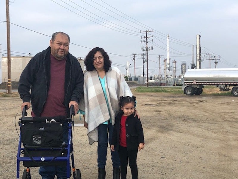 Jose Mireles, President of Comite Progreso de Lamont, and his family near refinery operations in Lamont.